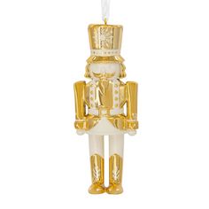 a gold and white nutcracker ornament