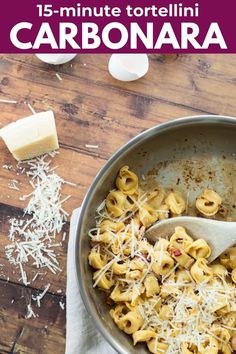 a pan filled with pasta and cheese on top of a wooden table