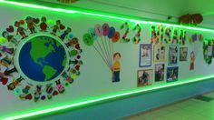 the wall is decorated with green lights and pictures on it, along with many balloons