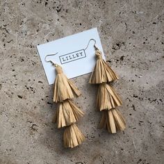 These beautiful raffia earrings in natural brown tan are delicately hand crafted using sustainable raffia. Ideal for both brides and bridesmaids or festival goers. Elegant Brown Adjustable Tassel Earrings, Handmade Brown Tassel Earrings, Beige Tassel Jewelry Gift, Elegant Brown Dangle Tassel Earrings, Elegant Brown Earrings For Beach, Elegant Brown Earrings For The Beach, Elegant Brown Beach Earrings, Raffia Accessories, Gold Bridal Hair Accessories