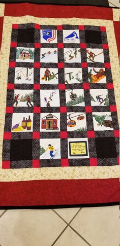 a red and black quilt with pictures on it