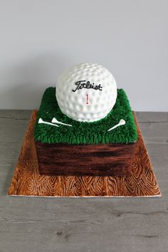 a cake made to look like a golf ball and tees