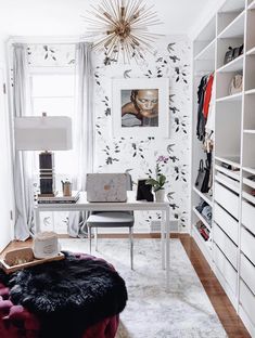 a room with white walls and black and white wallpaper