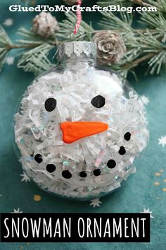 a snowman ornament hanging from a christmas tree with the words glue to my craft blog