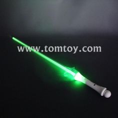 a green light saber on a black background