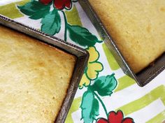 three pieces of cake sitting on top of a green and white cloth covered tablecloth