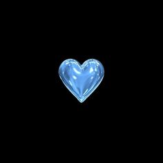 a blue heart shaped glass object on a black background with room for text or image