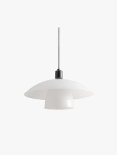 a white light hanging from a ceiling fixture with a black cord attached to the end