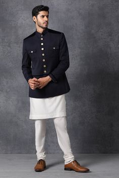 Dark blue bandhgala with front pockets detail.
Components: 1
Fabric: Suiting
Neckline: Band collar
Sleeve Length: Bracelet
Color: Blue
Lining material: Poly
Button placket on sleeve hems and pockets
Closure: Front button placket
Note: Kurta and pant worn by model are not for sale. - Aza Fashions Blue Bandhgala, Bandhgala For Men, Indian Handicrafts, Sherwani For Men, White Kurta, Suiting Fabric, Bespoke Suit, Bespoke Tailoring, Kurta With Pants