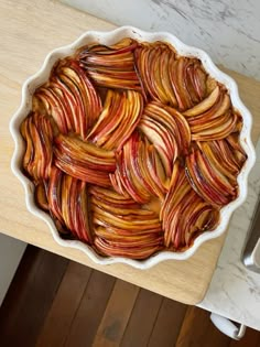 an apple pie sitting on top of a wooden table