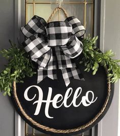 a black and white wreath with the word hello on it hanging from a metal door