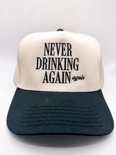 a black and white hat with the words never drinking again