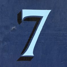 the number seven is painted on a blue tennis court