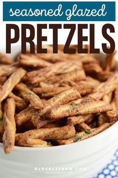 a white bowl filled with seasoned pretzels on top of a blue and white checkered table cloth