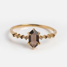 Elevate your style with our Solid Gold Smoky Quartz Hexagon Ring for Courage. The dark and moody stone exudes sophistication, while shining brilliantly for a touch of luxury.  Harvest Moon is a Local Eclectic exclusive. Smoky quartz 6.4 mm White topaz 0.9 mm 9k solid yellow gold  Band width 1.1 mm Care Instructions Use jewelry cleaner and a brush with soft bristles. You can also DIY clean with an old soft toothbrush and a mild dish-washing liquid. Rinse well and lay on a towel to dry. To buff ou Stone Wedding Ring, Hexagon Ring, Local Eclectic, Smoky Quartz Ring, Dark And Moody, Anniversary Jewelry, Black Jewelry, Solid Gold Jewelry, Quartz Ring