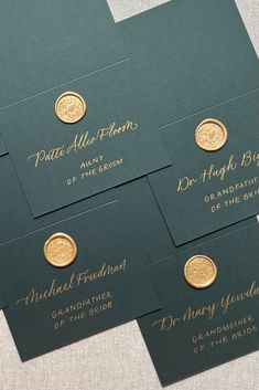 four green business cards with gold foil on them