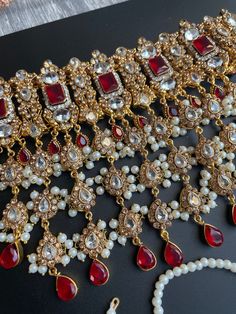 heavy bridal necklace for bride/Antique Traditional Choker for reception/Indian jewellery This complete semi bridal set comes with a gorgeous necklace in 2 finishes and color and matching tikka,passa,earrings. The pink has a silver finish along with pastel pink stones and the red has a maroon stone with antique gold finish. Red Kundan Bridal Necklace For Reception, Heavy Red Kundan Necklace For Wedding, Red Meenakari Bridal Necklace For Reception, Heavy Red Tikka For Wedding, Heavy Red Necklaces For Receptions, Heavy Red Necklaces For Reception, Heavy Red Bridal Necklace For Reception, Red Kundan Bridal Necklace With Intricate Design, Red Heavy Bridal Necklace For Ceremonial Use