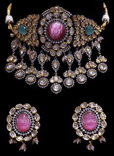 "Setting the tone for this season's wedding celebrations! A traditional piece crafted with centuries old form of handwork, this set exhibits beautiful kundan and lab-created emerald and ruby stone accents. The set includes a pair of beautiful earrings. Approximate earrings length is 2.5\". SET INCLUDES: Necklace & Earrings Details: Handcrafted Metal: Gold Plated, Metal Alloy Stone: Kundan, CZ Stones Closure: Post for Pierced Ears DELIVERY: * Ready To Ship *Customized Orders take 2 to 4 weeks, de Bridal Sets With Intricate Design For Diwali Reception, Diwali Bridal Sets With Intricate Design For Reception, Intricate Bridal Sets For Diwali Reception, Ceremonial Diamond Bridal Necklace With Intricate Design, Ceremonial Bridal Sets With Stone Work For Festive Occasions, Ceremonial Festive Bridal Sets With Stone Work, Traditional Bridal Sets With Intricate Design For Reception, Ceremonial Festive Bridal Set With Stone Work, Festive Ceremonial Bridal Sets With Stone Work