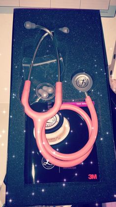 a pink stethoscope sitting on top of a counter