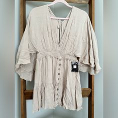 Step Up Your Boho-Chic Style With Our Bohemian Gauze Mini Dress. This Ultra-Feminine Dress Features A Deep V-Neck, Smocked Waistband And Intricate Button Detailing. The Billowy Sleeves And Mini Length Give It A Flirty Edge, While The 100% Rayon Gauze Fabric Keeps It Light And Airy. The Open Back With Tie At Shoulders Adds A Flirtatious Touch, Perfect For Summer Days And Nights. Billowy Sleeves, Ultra Feminine, Gauze Fabric, Feminine Dress, Boho Chic Fashion, Deep V Neck, Step Up, Summer Days, Smocking