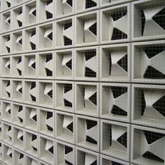 a wall made out of white tiles with black and white designs on it's sides