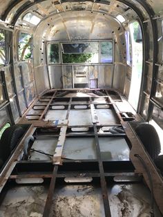 the inside of an old, run down vehicle with metal bars on it's sides