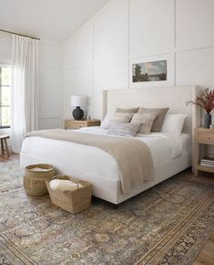 a large bed sitting in a bedroom on top of a rug