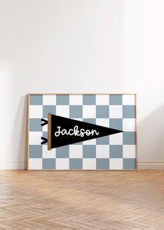 an empty room with a black and white checkerboard pattern on the wall next to a wooden floor