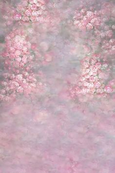 pink flowers are in the middle of a blurry background with white and gray colors