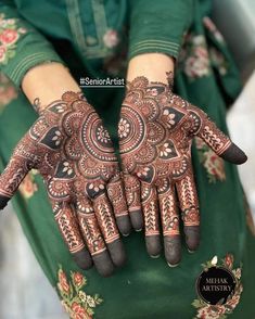 a woman's hands decorated with hennap and intricate designs on her hand