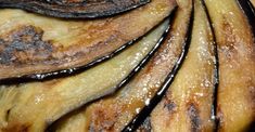 closeup of sliced bananas with brown and black streaks on them, in a dish