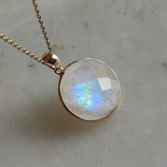 ITEM DESCRIPTION: This stunning necklace is set in 14k Solid Yellow Gold with Natural Rainbow Moonstone with utmost precision. It is an unique gemstone necklace for nearly every occasion and is completely hassle-free jewelry. ITEM DETAILS: * Gem: Rainbow Moonstone * Gem Size: 16x16mm * Gem Shape: Round * Gem Weight: 12.86 carats * Gold Purity: 14KT * Gold Weight: 0.50 gram * Total Weight: 3.07 gram The Gold purity is guaranteed and it comes with authentic 14KT gold hallmark. Since my items are h Moonstone Round Necklace For Anniversary, Yellow Gold Moonstone Gemstone Necklace, Yellow Gold Moonstone Necklace With Gemstone, Round 14k Gold Necklaces With Natural Stones, Moonstone Briolette Necklace For Gift, Faceted Round Moonstone Jewelry, Moonstone Round Necklace For Gifts, Briolette Moonstone Necklace For Gift, Faceted Moonstone Jewelry Gift