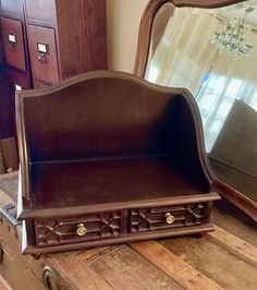 an old wooden dresser with drawers and mirror