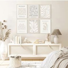 a bedroom with white furniture and pictures on the wall