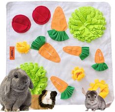 two small rabbits sitting next to each other in front of a wall with vegetables and carrots on it