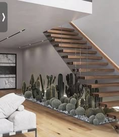 a living room filled with furniture next to a stair case covered in cacti