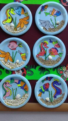 the plates have different designs on them and are painted to look like sea animals in water