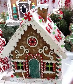 an image of a gingerbread house with candy canes on the roof and windows