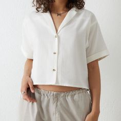 Nwt Dobby Crop Button Up Shirt From Urban Outfitters (Uo London) Size M Light And Breezy Dobby Shirt In A Boxy Silhouette Features A Revere Collar Drop Shoulders Short Sleeves Swiss Dot Over Striped Body Off- White / Ivory Material: 100% Cotton Msrp: 26.00 ~$35 (Was Purchased In London So Tag Is In Gbp) Measurements (Approx, Lying Flat): Shoulder To Shoulder: 20.5” Armpit To Armpit: 23.5” Bottom Hem Width: 23” Full Length (Shoulder To Bottom Hem): 20” Armpit To Bottom Hem: 10” Sleeve Length: 7.5 Summer Button-up Top With Placket, Casual Button-up Blouse With Placket, Summer Button-up Tops With Button Closure, Summer Button-up Workwear Shirt, Summer Workwear Button-up Shirt, Summer Button-up Shirt For Workwear, Casual Relaxed Fit Tops With Back Button Closure, Casual Collared Shirt With Back Button Closure, Casual Tops With Relaxed Fit And Back Button Closure