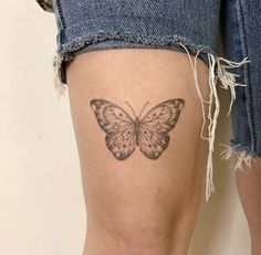 a woman's thigh with a tattoo of a butterfly on the lower part of her leg