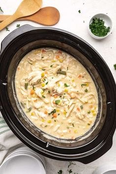 a crock pot filled with chicken noodle soup