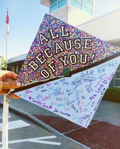 someone holding up a kite with writing on it