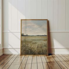 an empty room with a painting on the wall and wood flooring in front of it