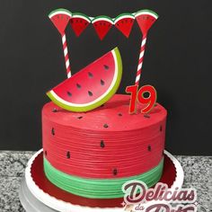 a watermelon themed cake is displayed on a table