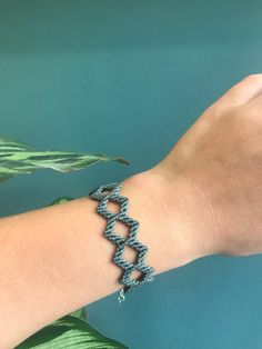 a woman's arm with a bracelet made out of beads