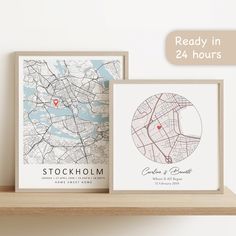 two framed maps sitting on top of a wooden shelf next to each other with the words stockholm in red