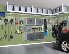 a car parked in front of a garage with tools on the wall and shelves above it