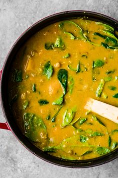 a pot filled with green vegetables and sauce