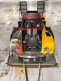 an old car is being worked on in a garage