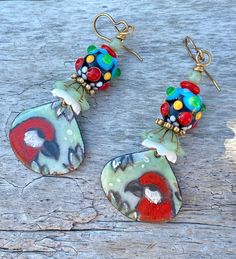 Adorable red cardinals are handpainted by Artisan artist Detelina. I've paired them with colorful lampwork beads, ceramic bead caps and spacer beads.   They hang approximately 2 1/2 inches from the top of the ear wires.  Very light and perfect for the holiday season! Hand Painted Red Polymer Clay Earrings, Red Hand Painted Polymer Clay Earrings, Whimsical Red Hand Painted Jewelry, One Of A Kind Multicolor Earrings As Gift, Whimsical Handmade Red Earrings, Multicolor Bird Design Earrings As A Gift, Gift Multicolor Bird Design Earrings, Multicolor Bird Design Earrings For Gift, Multicolor Bird Design Earrings Gift